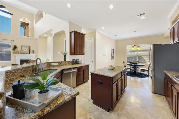 a kitchen with stainless steel appliances granite countertop a stove a sink dishwasher a refrigerator and a oven