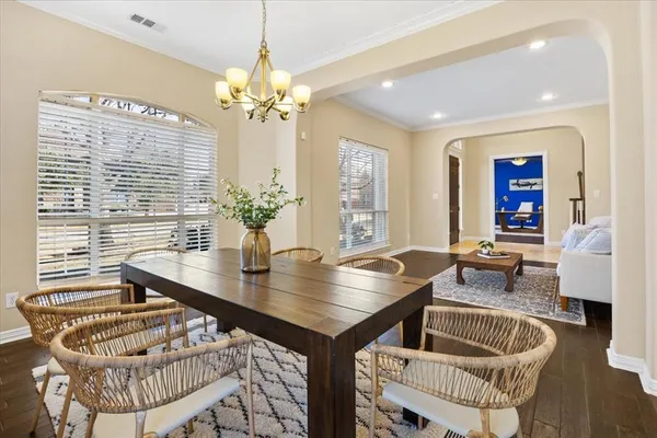 a dining room with furniture and wooden floor