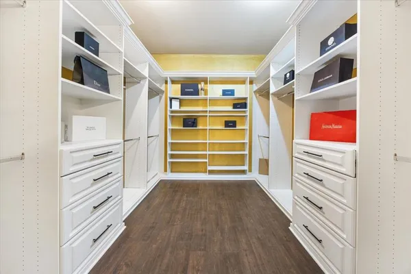 an empty room with chandelier fan and windows