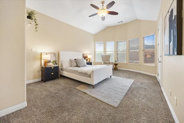 a spacious bedroom with a bed and a couch