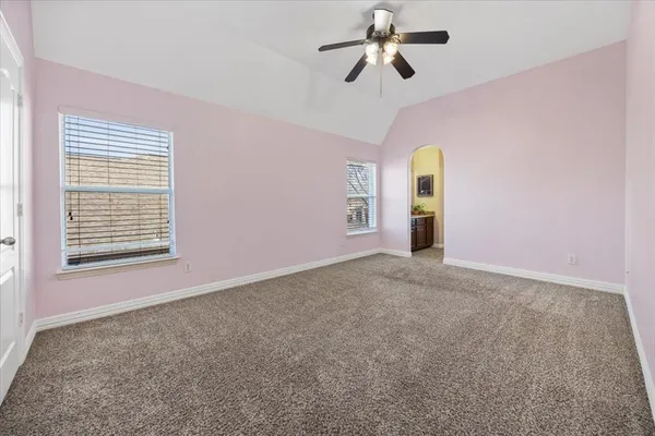 a bedroom with a bed couch and window