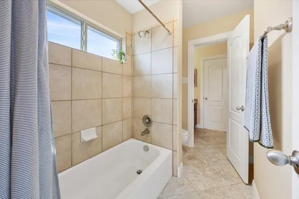 a bathroom with a bathtub and a toilet