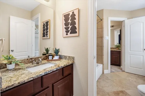 a bathroom with a tub shower and window