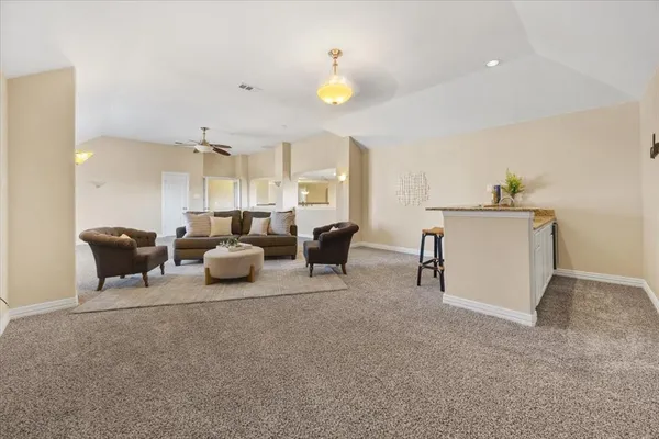 a living room with furniture and a chandelier