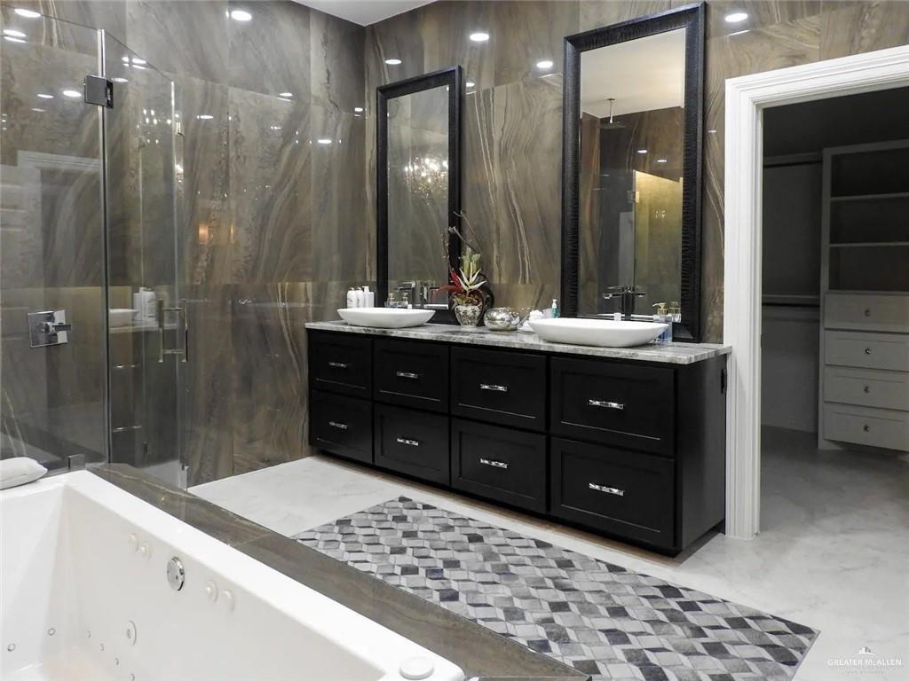 1413 Encantado Circle Palmview, TX 78572 - Photo 14 of 25 a bathroom with a sink vanity granite tub shower and a mirror