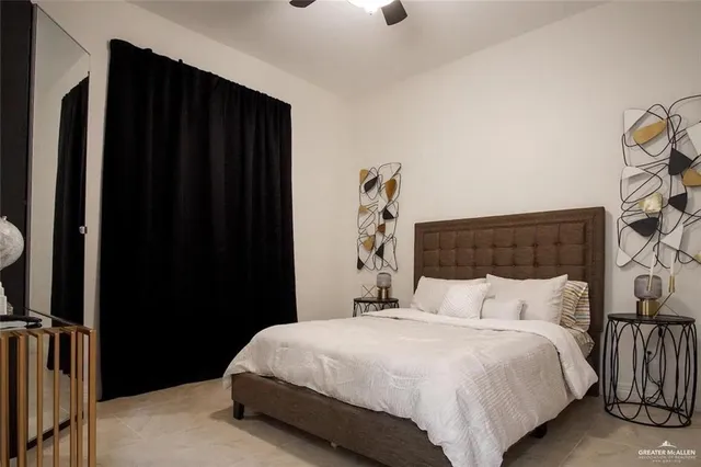 a bedroom with a bed and a mirror