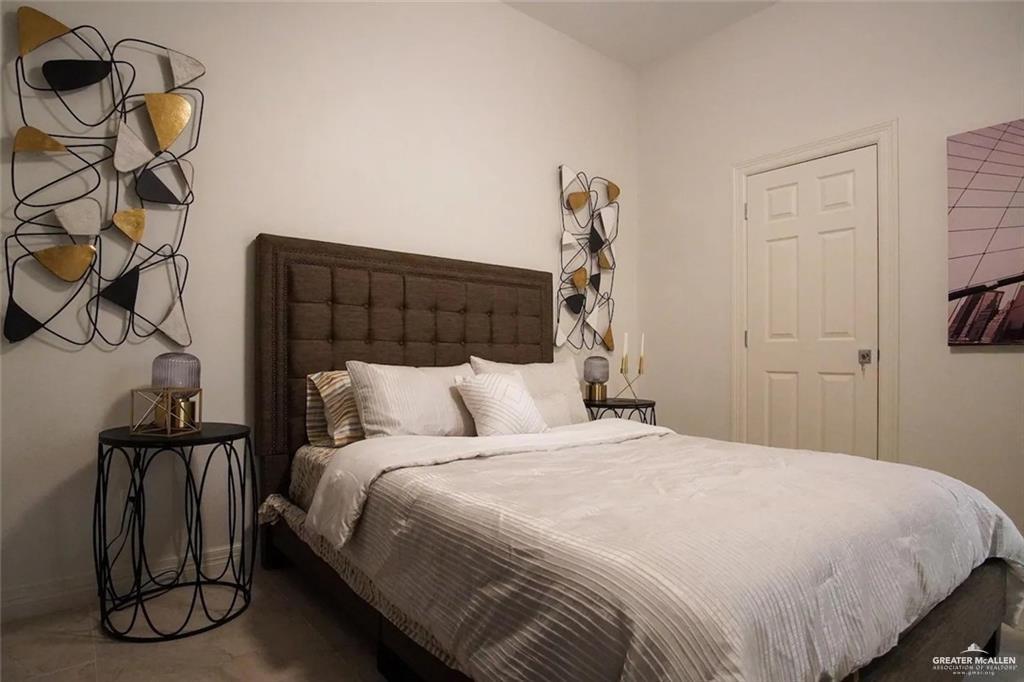 1413 Encantado Circle Palmview, TX 78572 - Photo 18 of 25 a bedroom with a bed and a mirror