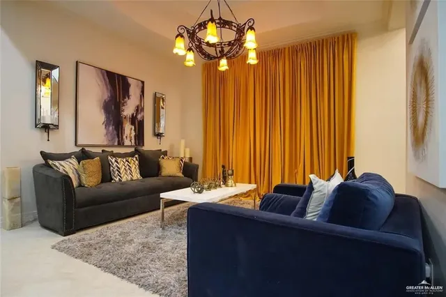 a living room with furniture and a chandelier