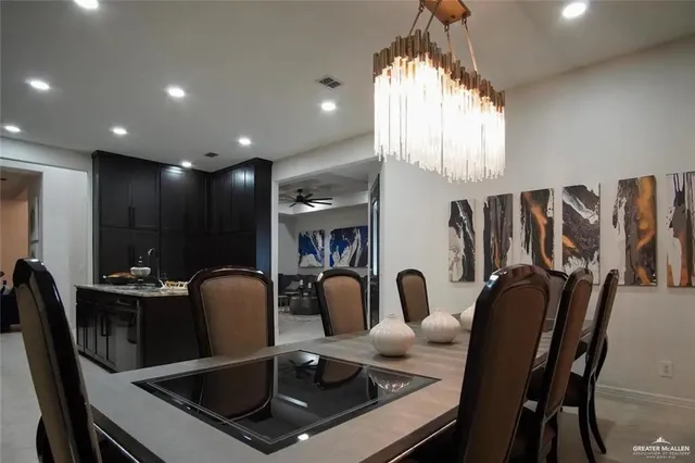 a dining room with furniture a window and chandelier