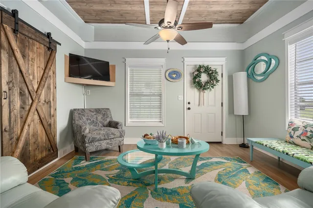 a living room with furniture and a flat screen tv