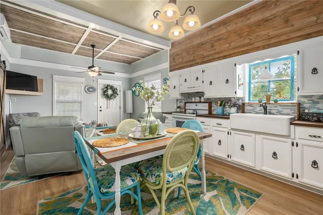 a view of a dining room with furniture and a chandelier