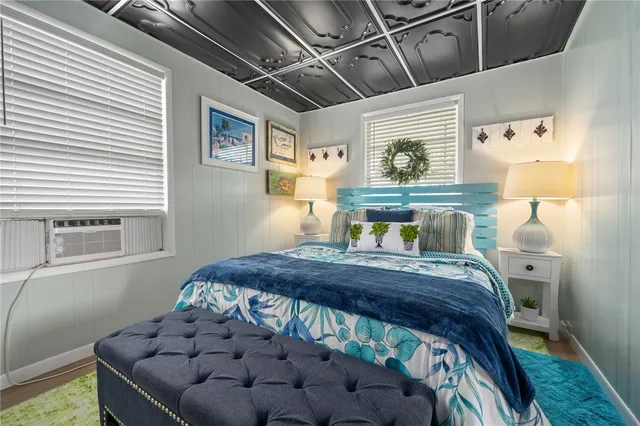 a bed sitting in a bedroom next to a window