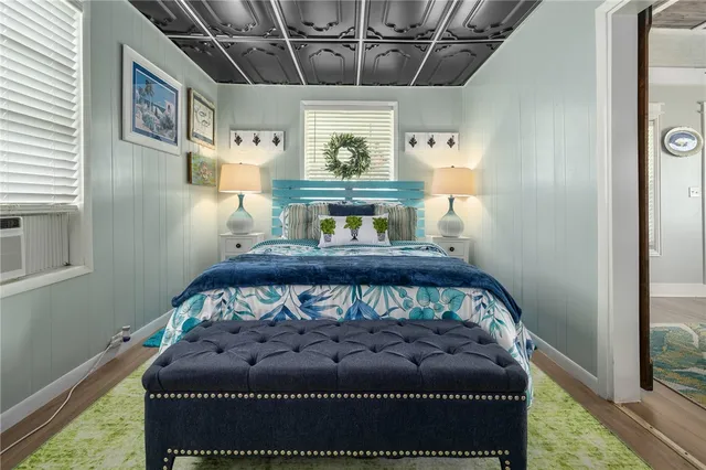 a bed sitting in a bedroom next to a window