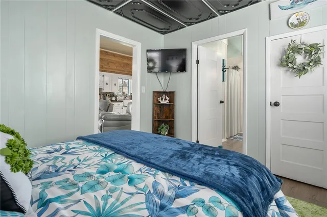 a bedroom with a bed dresser and a window