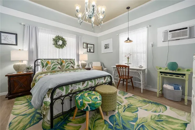 a bedroom with a bed and a chandelier