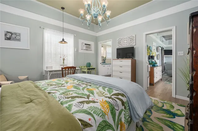 a bedroom with a bed and a chandelier