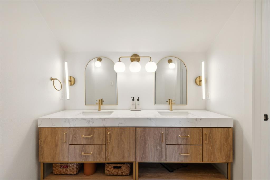 9427 Hobart Street Dallas, TX 75218 - Photo 14 of 25 a bathroom with a double vanity sink and a mirror