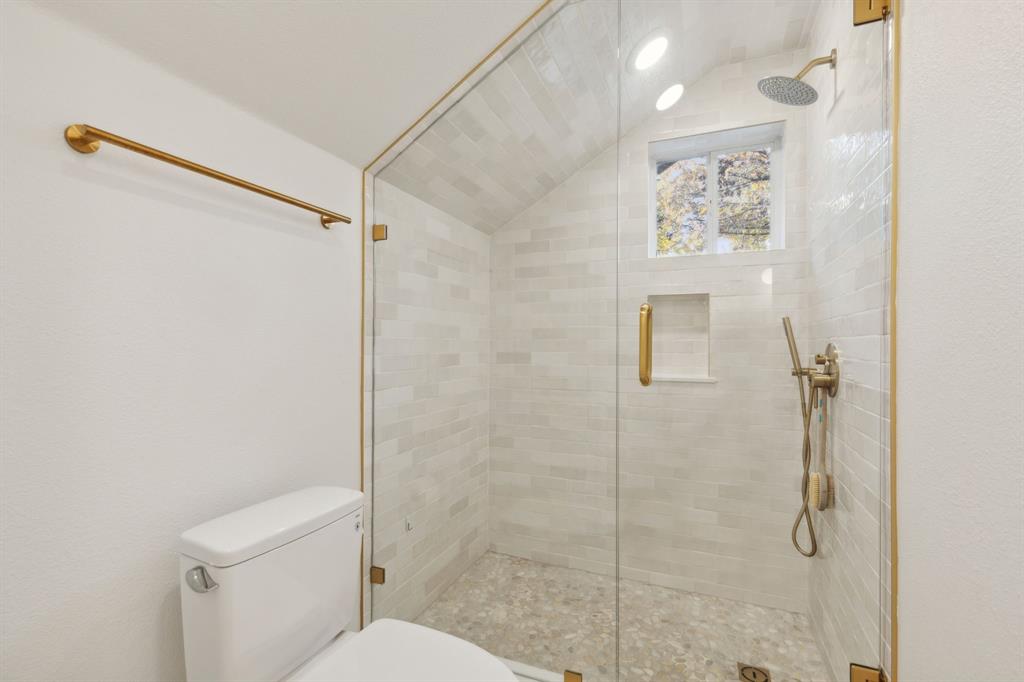 9427 Hobart Street Dallas, TX 75218 - Photo 15 of 25 a bathroom with a shower and toilet