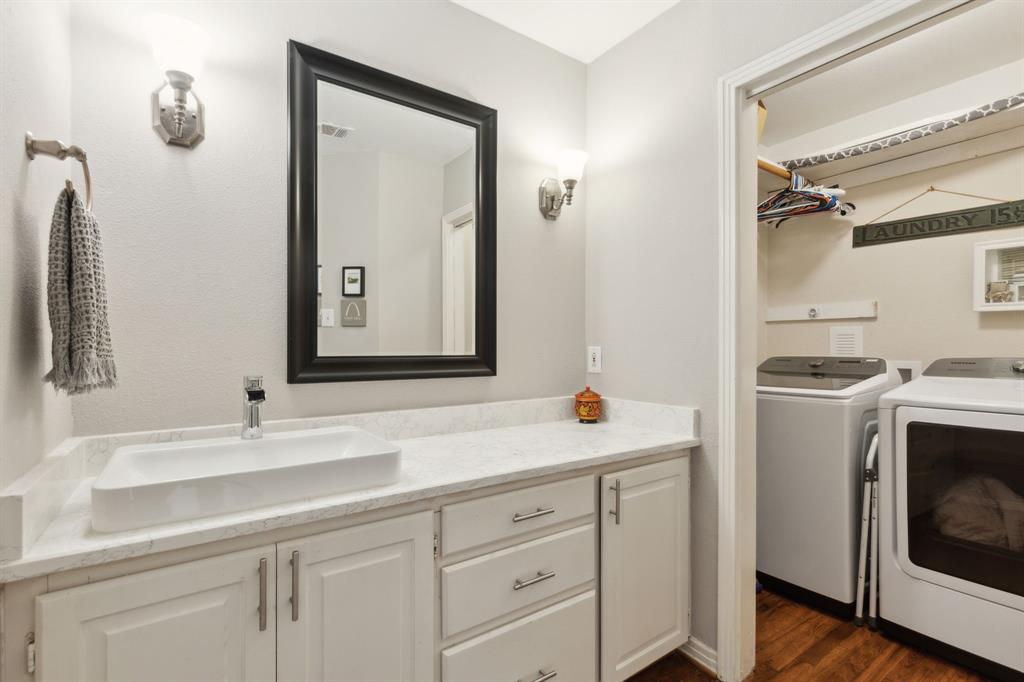 9427 Hobart Street Dallas, TX 75218 - Photo 21 of 25 a bathroom with a sink and a mirror