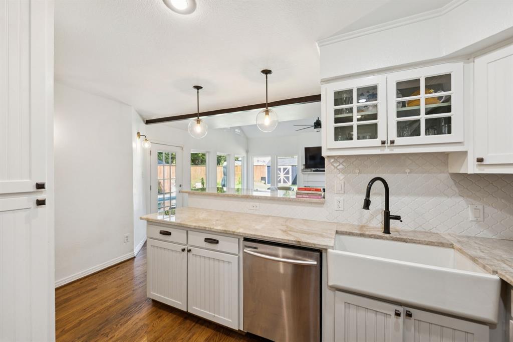 9427 Hobart Street Dallas, TX 75218 - Photo 7 of 25 a kitchen with stainless steel appliances granite countertop a sink and wooden floor