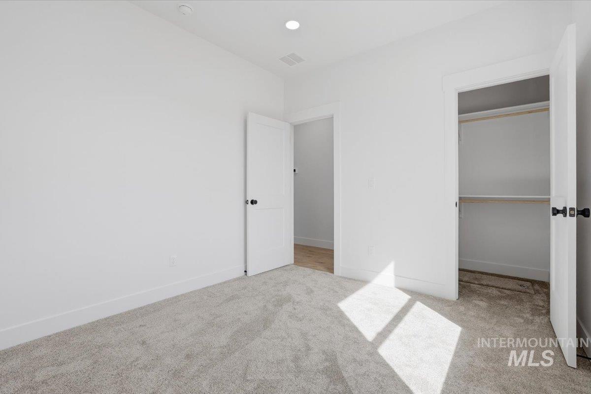 2175 Austin Way Fruitland, ID 83619 - Photo 16 of 30 Unfurnished bedroom with light carpet, a closet, and recessed lighting