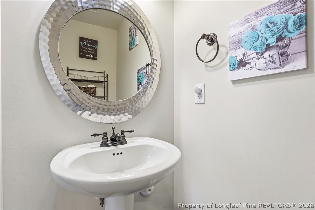 886 Micahs Way North Spring Lake, NC 28390 - Photo 17 of 50 a bathroom with a sink and mirror