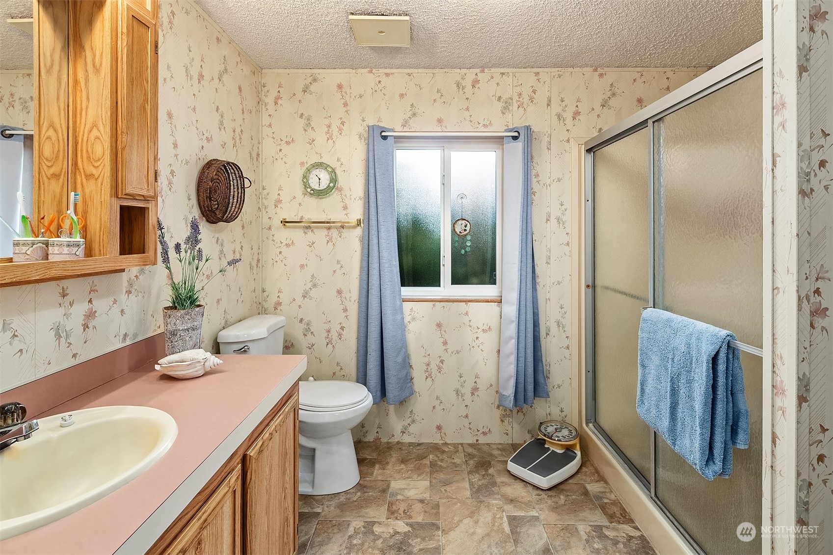 5810 Fleming Street, Unit 33 Everett, WA 98203 - Photo 15 of 28 a bathroom with a sink a toilet and shower