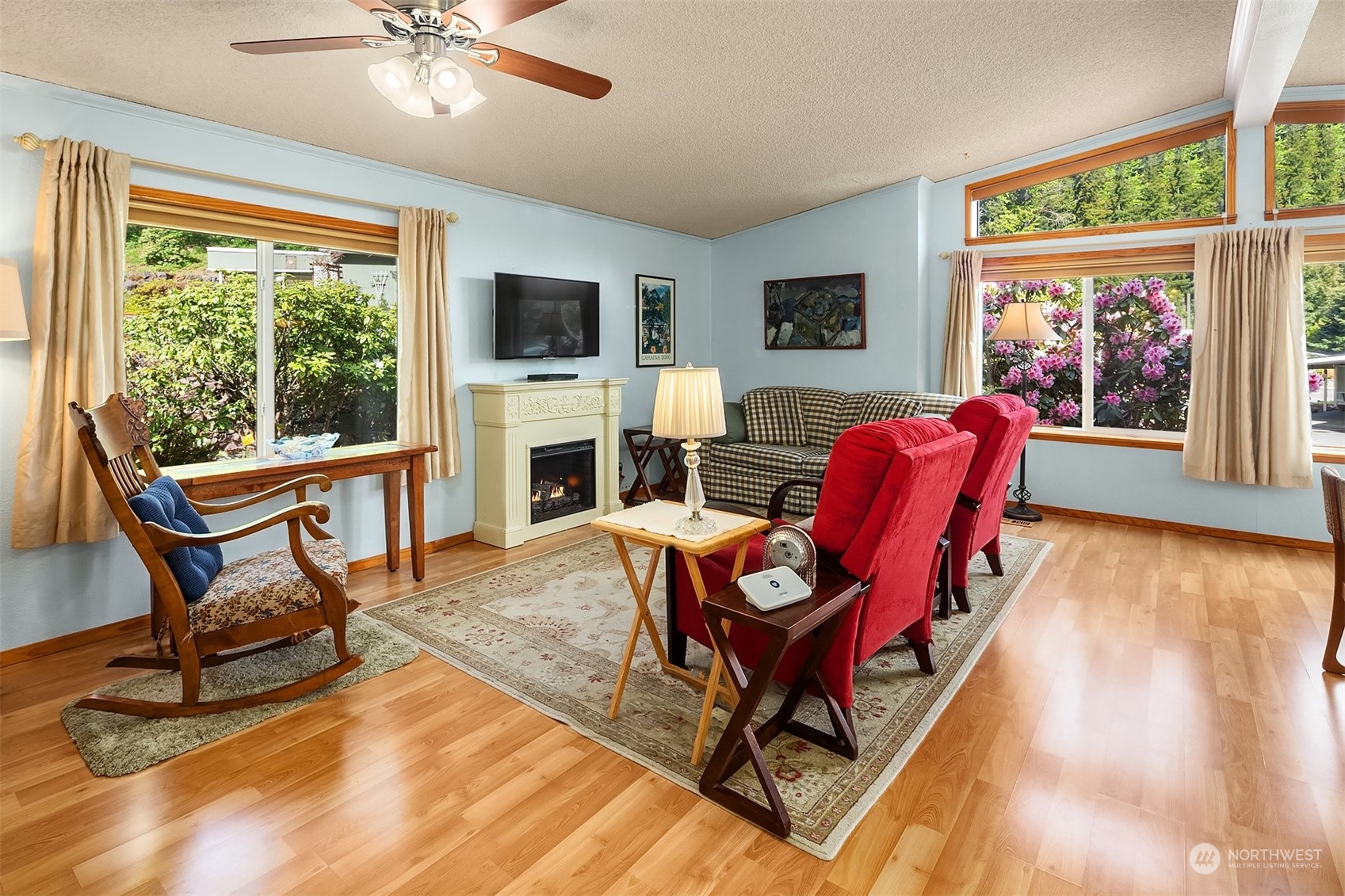 5810 Fleming Street, Unit 33 Everett, WA 98203 - Photo 7 of 28 a living room with furniture a flat screen tv and a floor to ceiling window