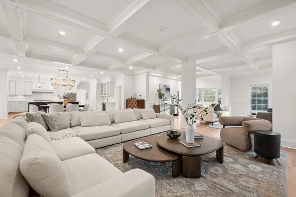 a living room with furniture and view of kitchen