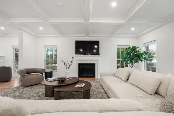 a living room with furniture a fireplace and a flat screen tv