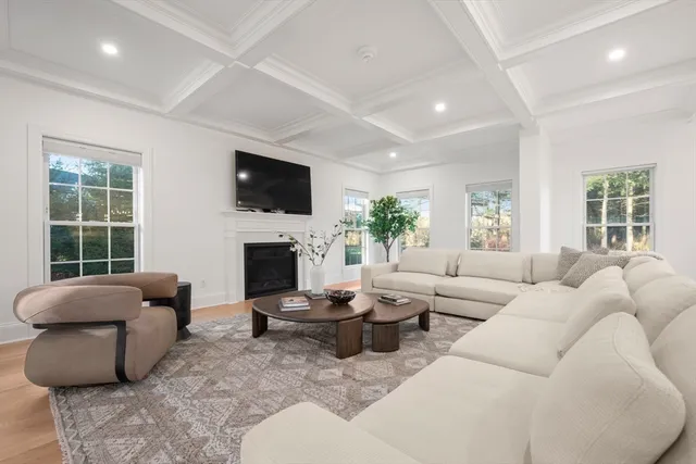a living room with fireplace furniture and a flat screen tv