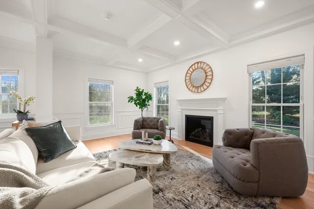 a living room with furniture a window and a fireplace