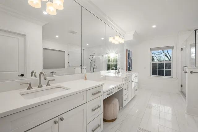 a large bathroom with a double vanity sink mirror and a bathtub
