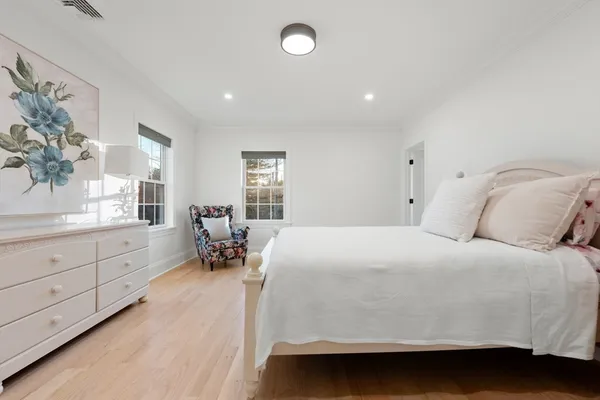 a room with a bed and a large window