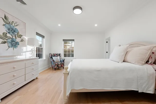 a room with a bed and a large window