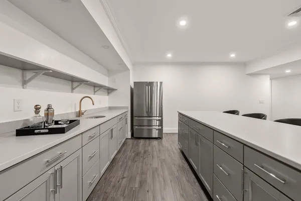 a large kitchen with stainless steel appliances lots of counter space sink and cabinets