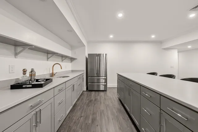 a large kitchen with stainless steel appliances lots of counter space sink and cabinets