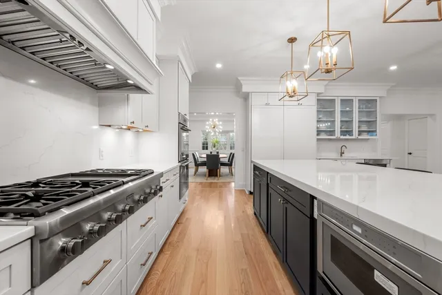 a kitchen with granite countertop a sink stove and cabinets