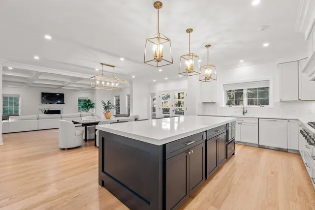 a kitchen with stainless steel appliances granite countertop a sink stove and wooden floor