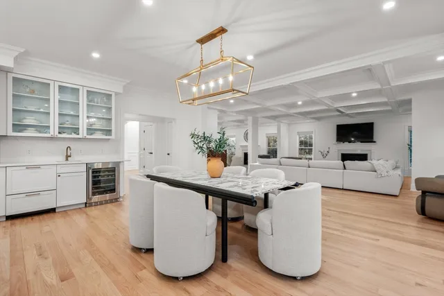 a kitchen with stainless steel appliances granite countertop a sink cabinets and wooden floor