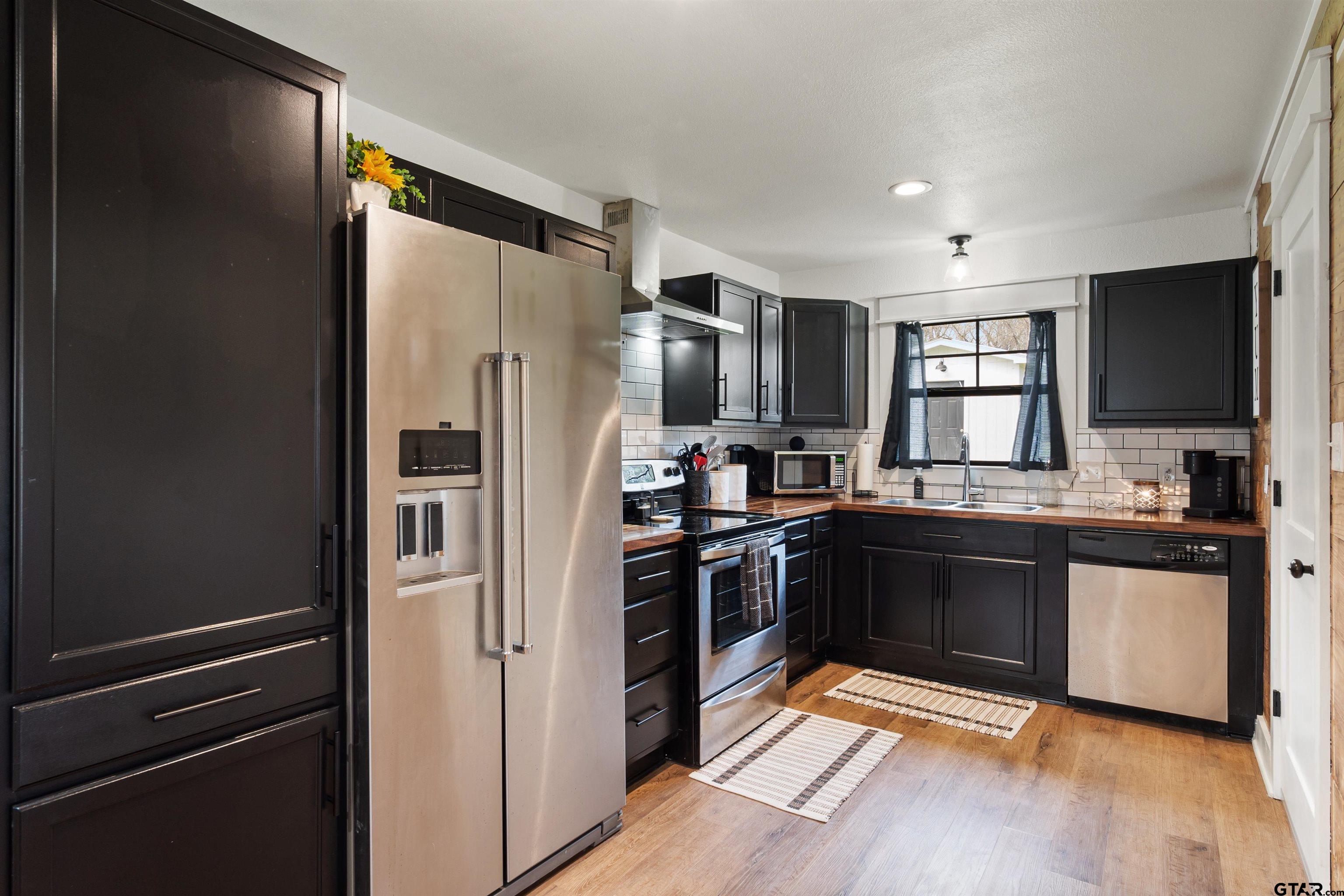 232 Farm To Market 1248 Rusk, TX 75785 - Photo 6 of 19 a kitchen with stainless steel appliances granite countertop a refrigerator and a sink