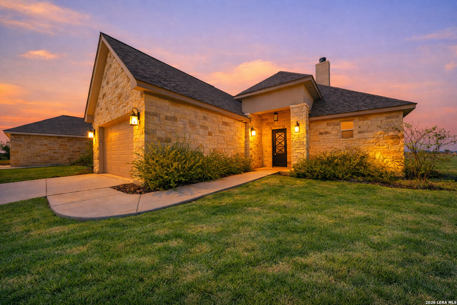 123 John T Court Castroville, TX 78009 - Photo 1 of 45 a front view of a house with a yard and garage