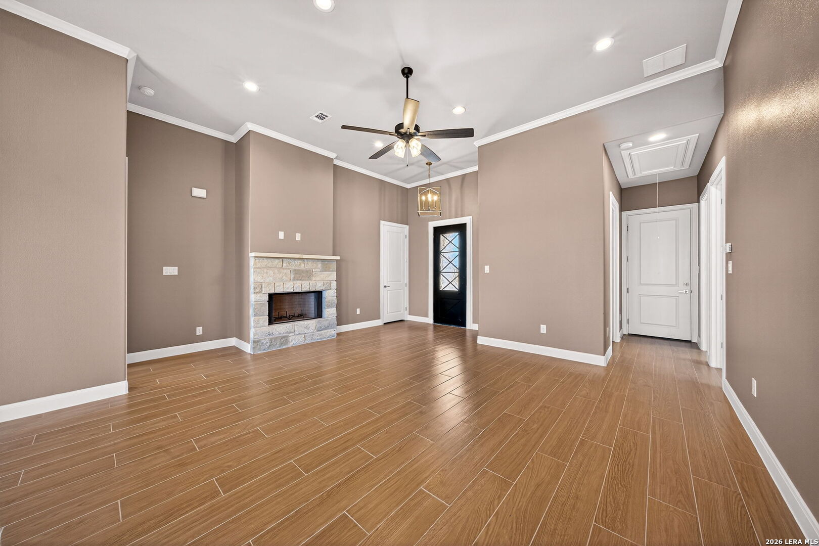 123 John T Court Castroville, TX 78009 - Photo 11 of 45 an empty room with wooden floor ceiling fan and windows