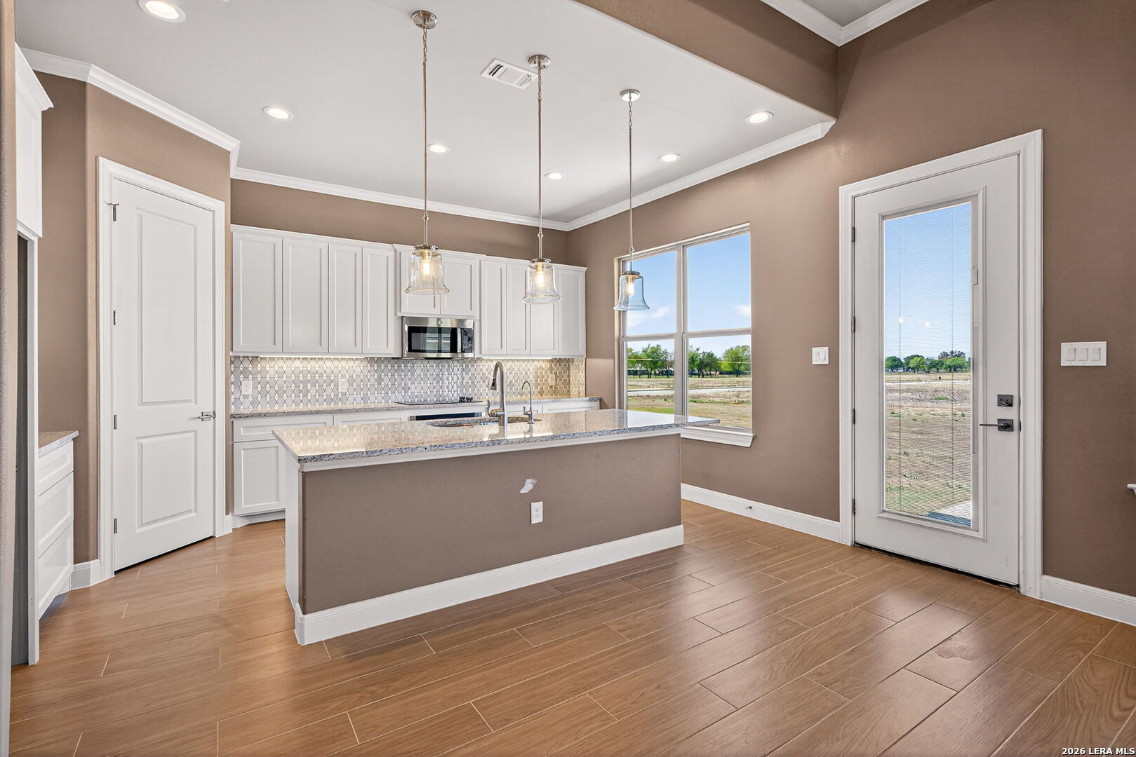 123 John T Court Castroville, TX 78009 - Photo 12 of 45 a large kitchen with kitchen island a sink stainless steel appliances and cabinets
