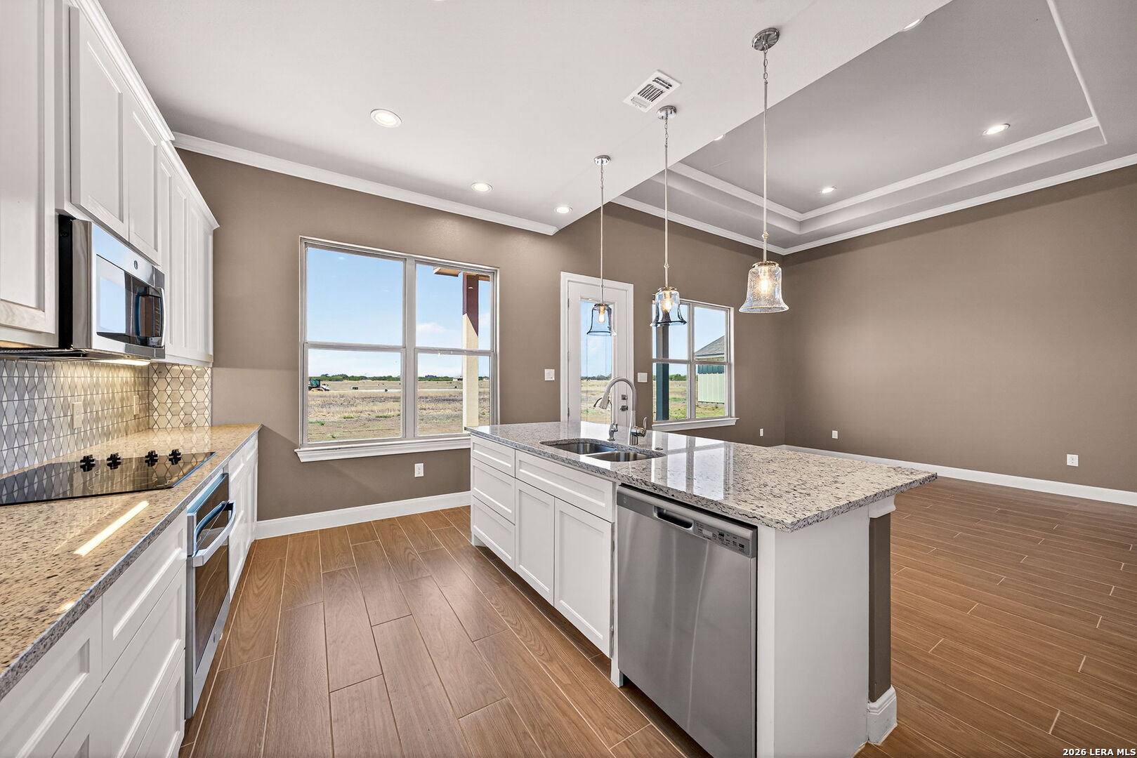 123 John T Court Castroville, TX 78009 - Photo 13 of 45 a kitchen with stainless steel appliances granite countertop a sink stove and refrigerator