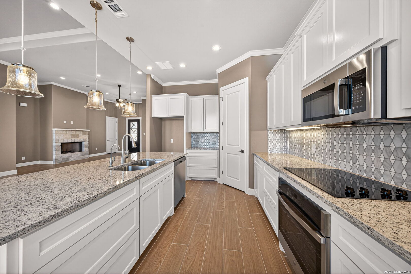 123 John T Court Castroville, TX 78009 - Photo 14 of 45 a kitchen with stainless steel appliances granite countertop a sink and stove