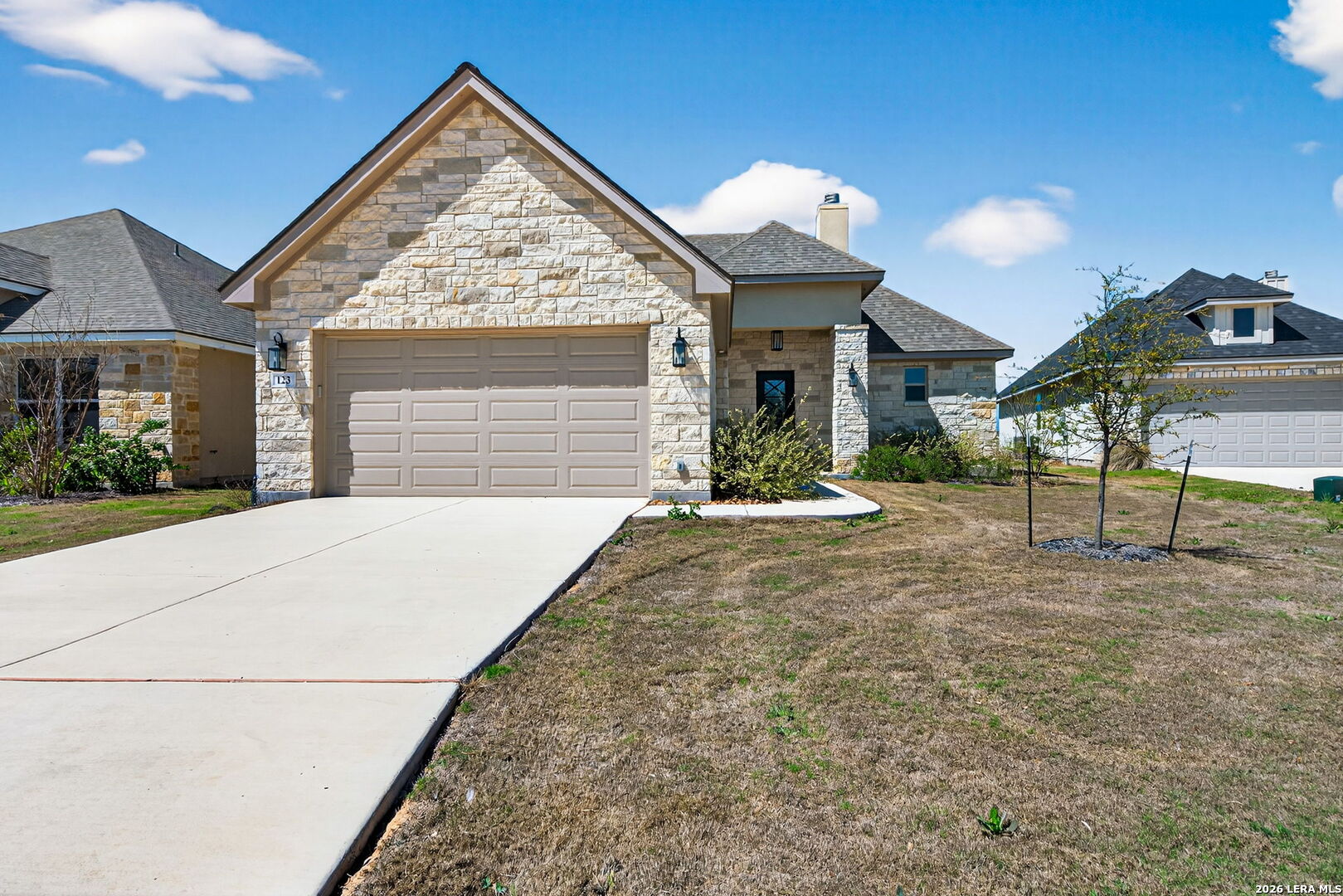 123 John T Court Castroville, TX 78009 - Photo 2 of 45 a view of a house with a backyard and a garage