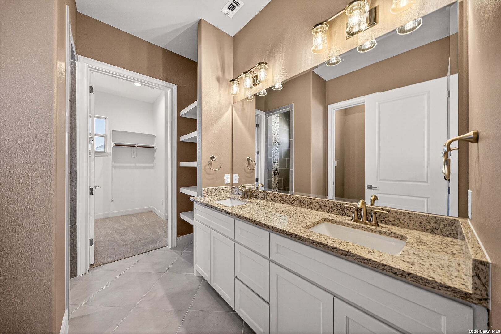 123 John T Court Castroville, TX 78009 - Photo 21 of 45 a bathroom with a granite countertop double vanity sink a mirror and a shower