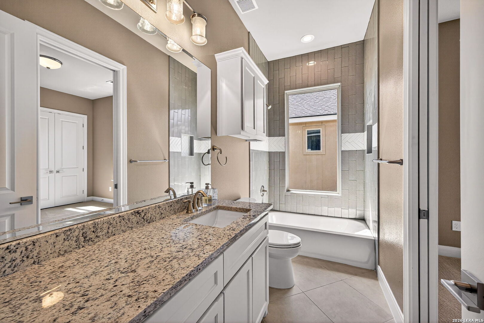 123 John T Court Castroville, TX 78009 - Photo 26 of 45 a bathroom with a granite countertop tub sink and mirror