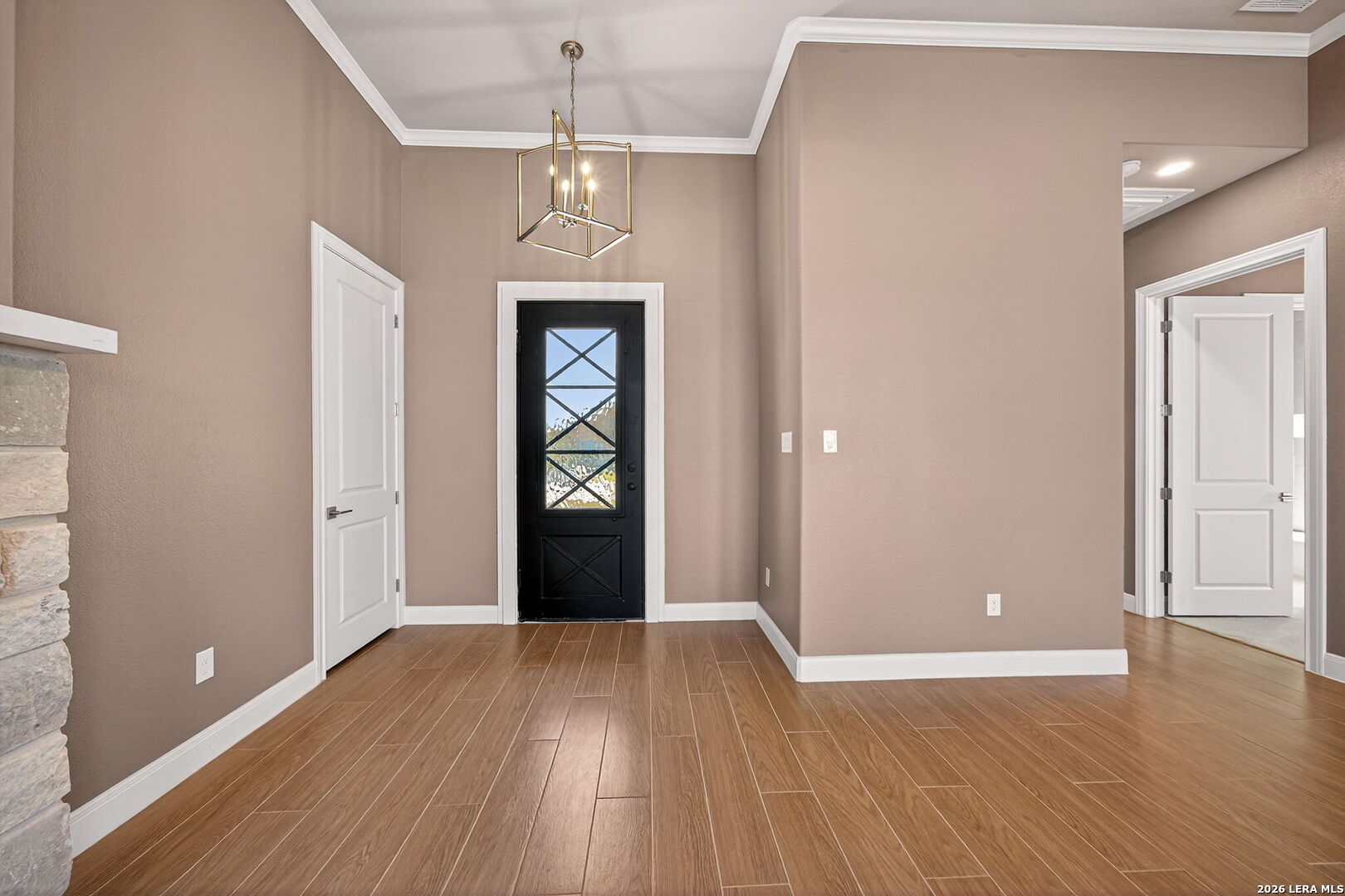 123 John T Court Castroville, TX 78009 - Photo 7 of 45 wooden floor in an empty room with a window